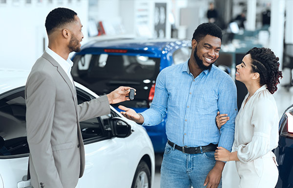 Lovely couple talking to car agent photo